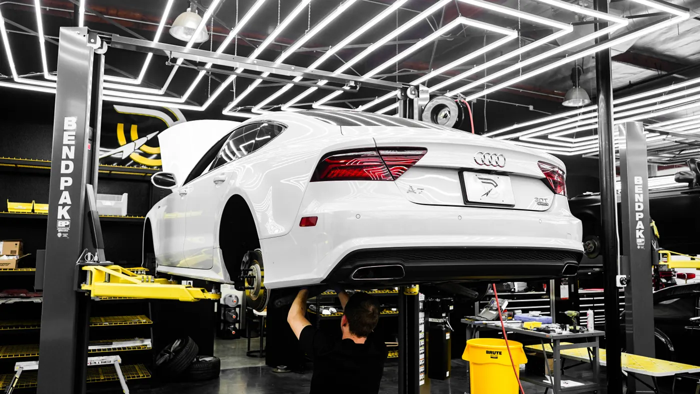 Performance car being inspected in a professional workshop