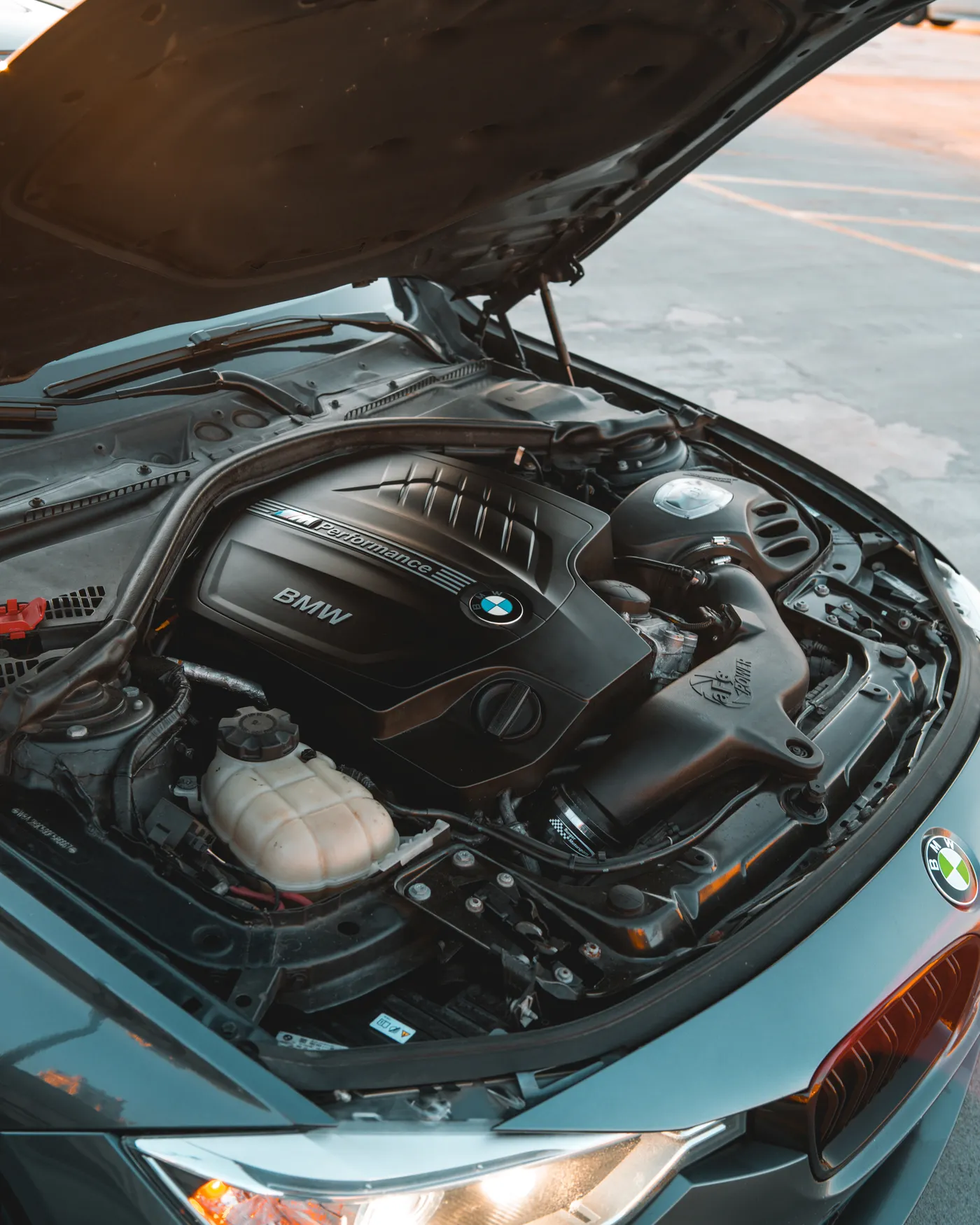Car with its hood open during inspection